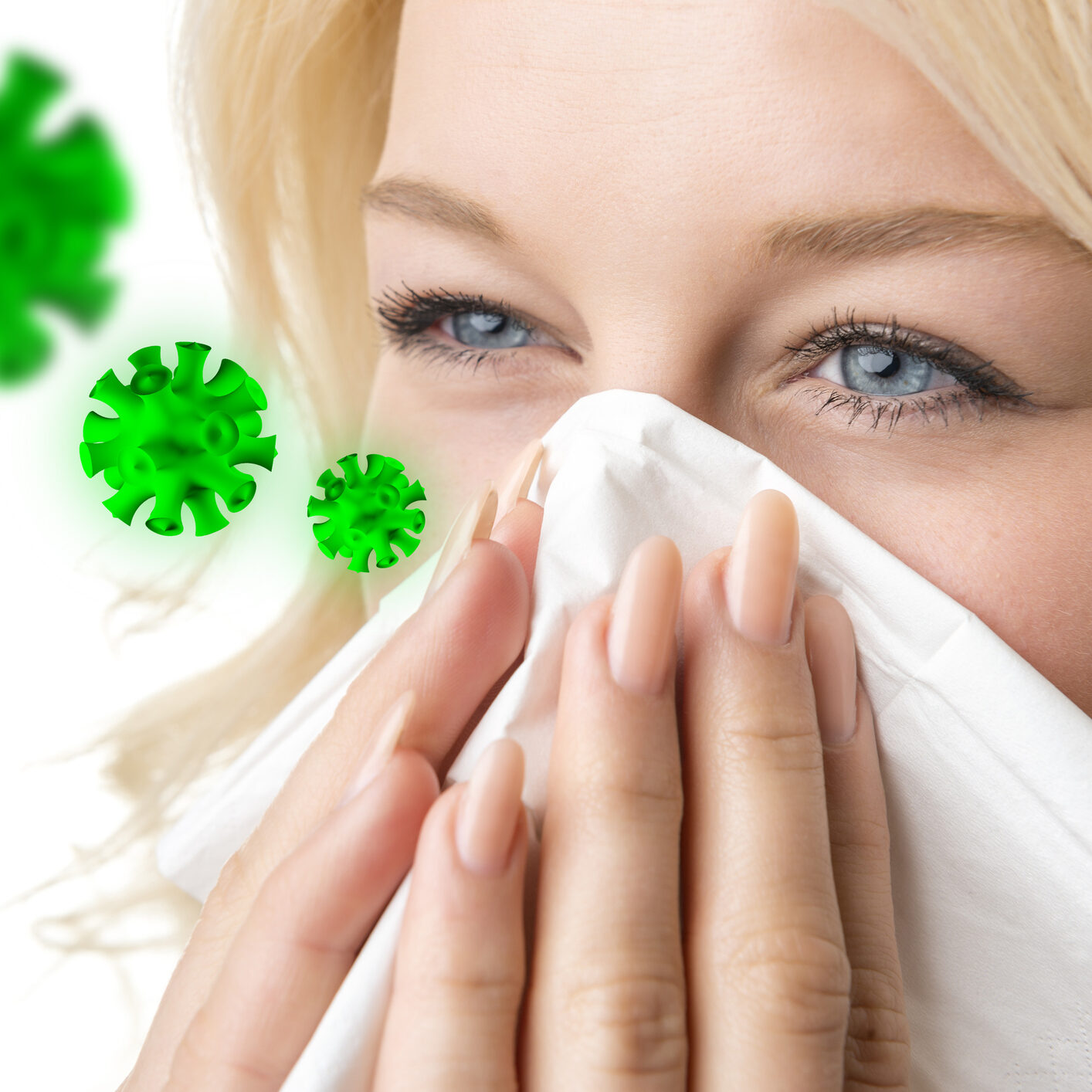 Portrait of a ill blond woman who is sneezing virus in a tissue